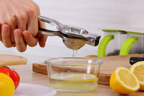 You can use a lemon squeezer to ensure hygiene